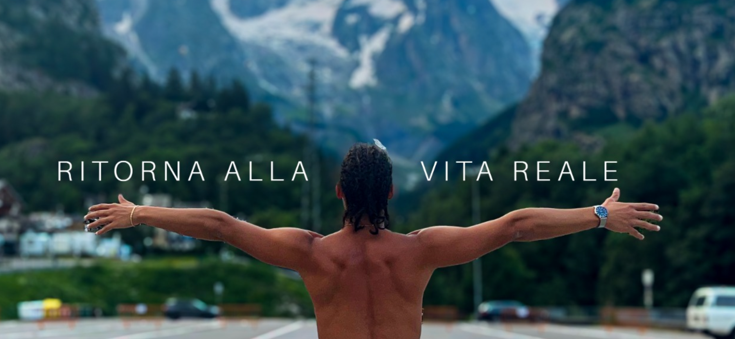 Nature Cosmos slogan "ritorna alla vita reale" , a youngman wingspan facing some mountains